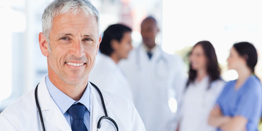 Smiling doctor with a medical team